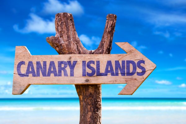 Canary Islands wooden sign with beach background